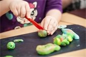 Kids playing with playdough.