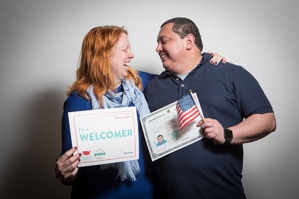 Photo of a woman welcoming a new citizen at the 2017 Naturalization Ceremony.