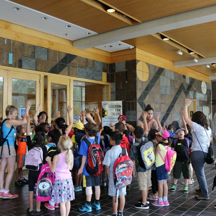 School children with backpacks entering the library.